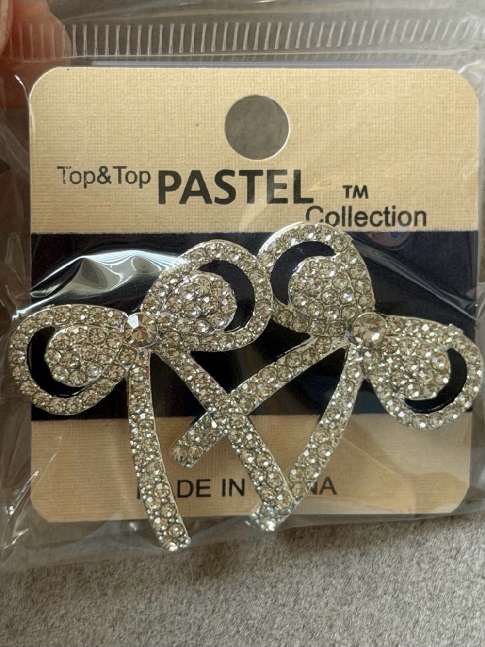 Silvertone rhinestone bow earrings